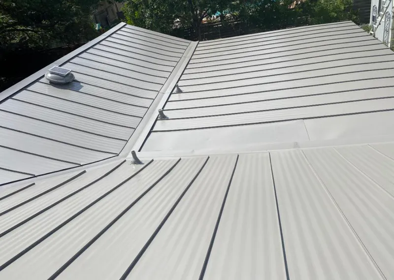 Solar attic fan installed on a metal roof for Roof Ventilation in Port Jefferson